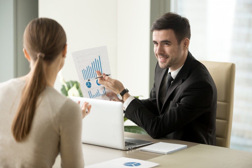 businessman presenting a graph to a client