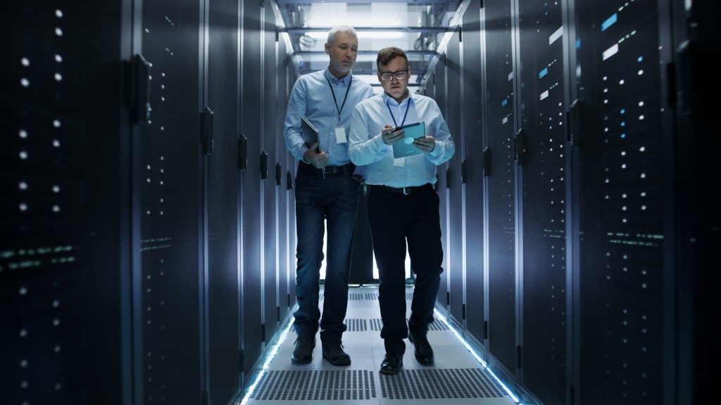 IT personnel checking data center