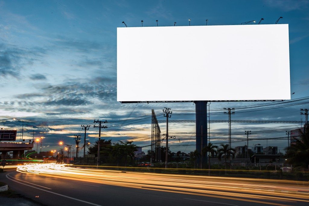 A blank billboard in the highway at night