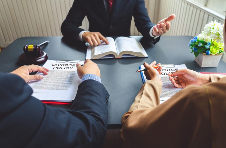 A lawyer talking to a couple with Divorce Policy documents in front of them