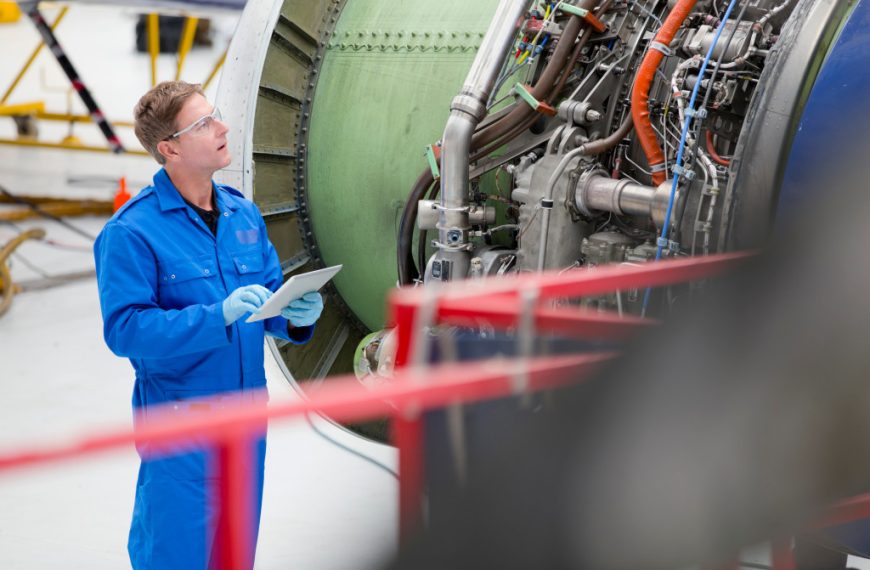 man inspecting aircraft