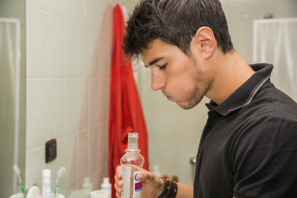 A man using mouthwash