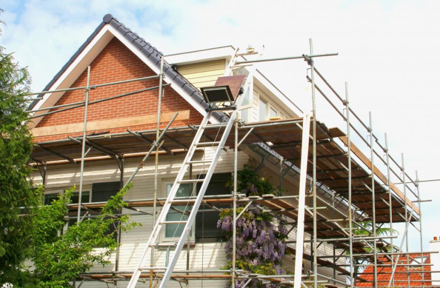 house being renovated with ladders and structures all around