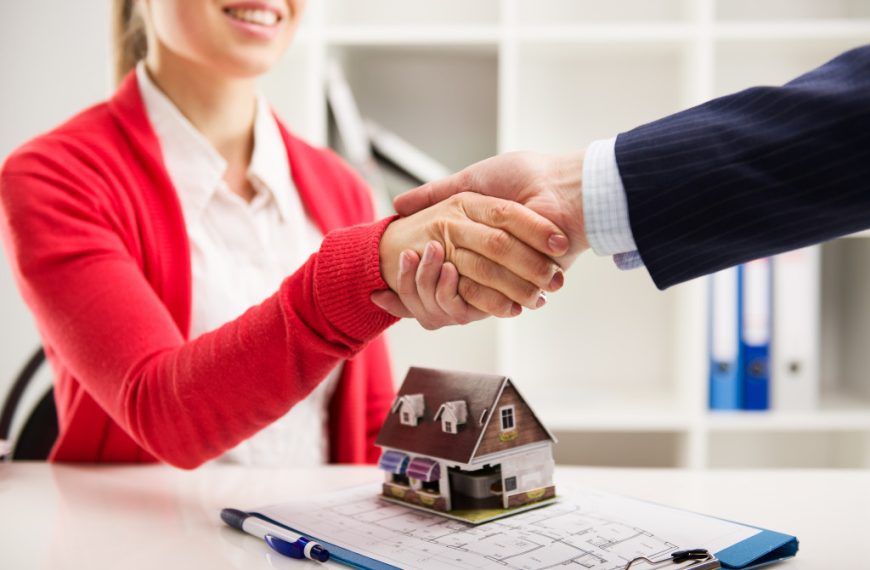 Two real estate businesspeople shaking hands