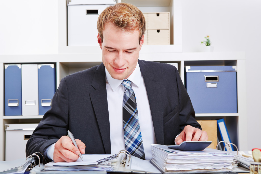 a male accounant working in his office
