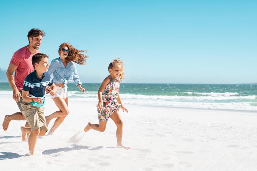 Happy mother and smiling father with two children