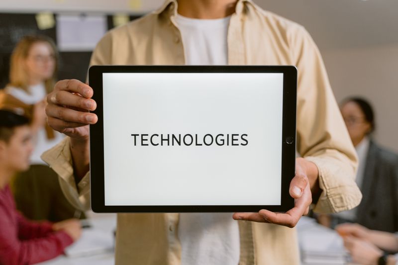 a woman holding a technologies sign